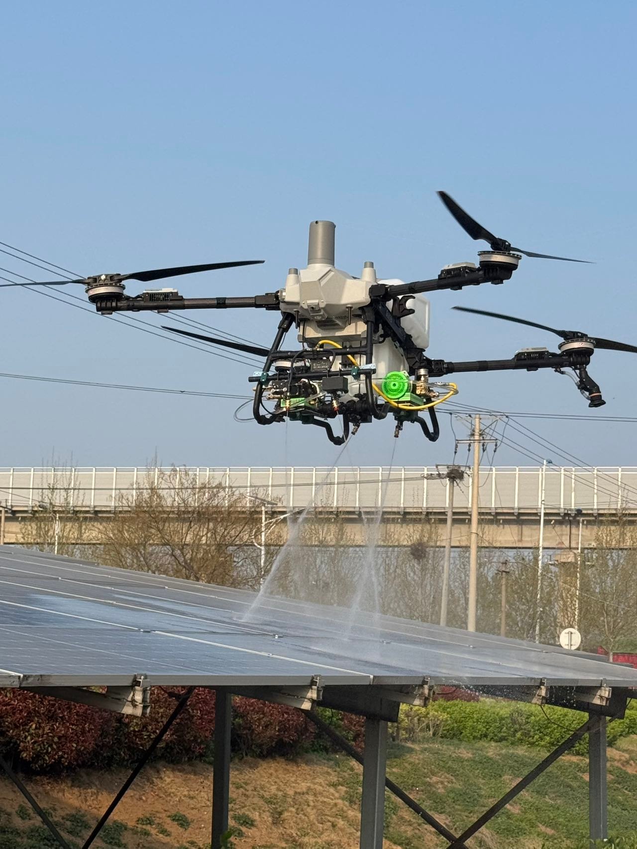 UAV cleaning a solar panel array