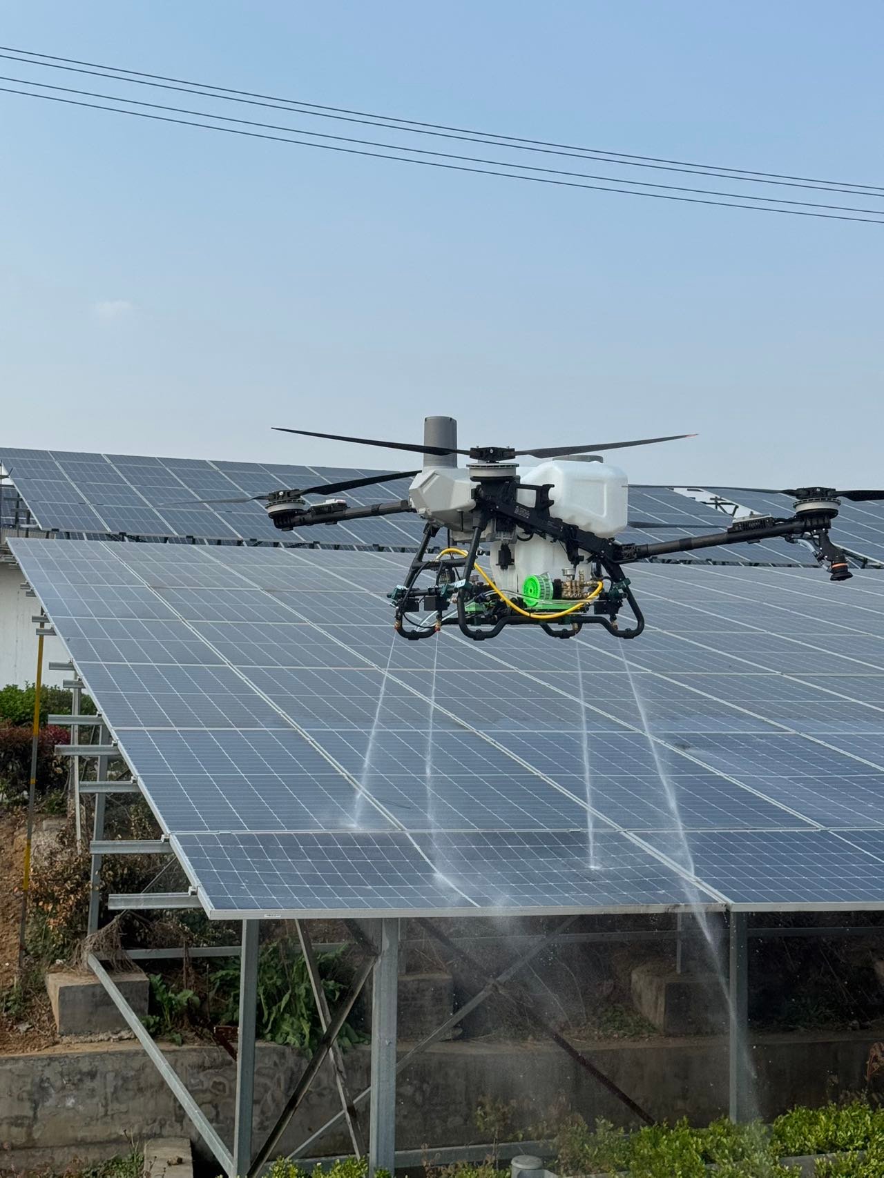 UAV cleaning a photovoltaic installation